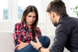Image of woman being talked to by male partner, for post on The Couples Tool Kit about manipulating in communication.